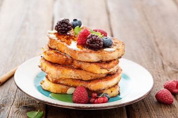 French toasts with fresh berries and honey for breakfast.