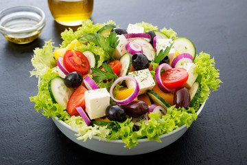 Greek salad with feta cheese, organic black olives, juicy tomatoes, red pepper, red onion, cucumber and lettuce.
