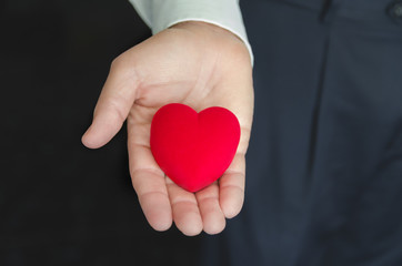 Fototapeta premium Man giving red heart. Saint Valentines day or Love concept. Copy space.