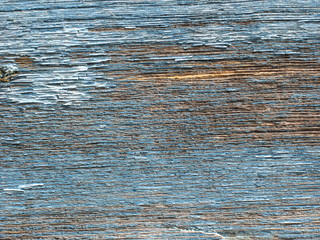 Wood board texture background with blue dry peeling paint and cracks