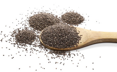 Chia seed pile with wooden spoon isolated on white background