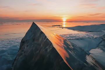 Ice hummock at ice of lake Baikal on sunset