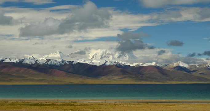 4k time lapse of huge clouds mass rolling over lake namtso & Tanggula snow mountain peak,tibet mansarovar,Tibet's second largest lake,is the third largest saltwater lake in China.