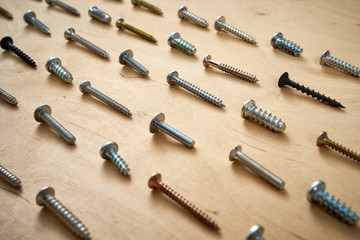 pattern background of various screws on a  wooden work table