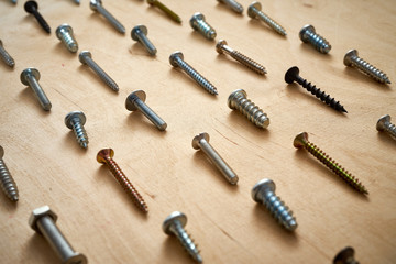 pattern background of various screws on a  wooden work table