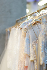 Few beautiful wedding dresses on a hanger.