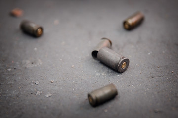 Bullet shell on gray concrete background. Shooting range