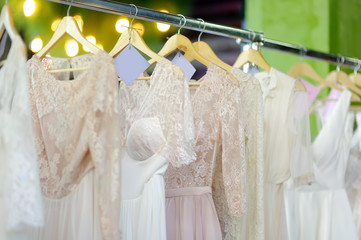Few beautiful wedding dresses on a hanger.