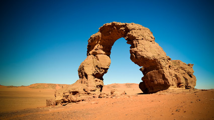 Arch Rock formation aka Arch of Africa or Arch of Algeria with moon at Tamezguida in Tassili nAjjer national park in Algeria © homocosmicos