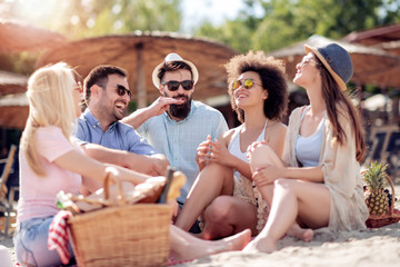 Joyful team of friends having fun at the beach