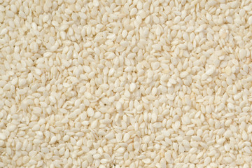 White peeled sesame seeds close up, background, texture