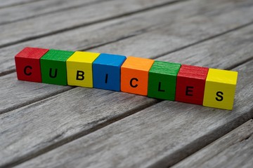 colored wooden cubes with letters. the word cubicles is displayed, abstract illustration