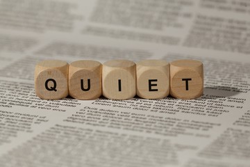 wooden cubes with letters. the word quiet is displayed, abstract illustration