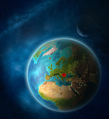 Romania from space on planet Earth in space with Moon and Milky Way. Extremely fine detail of planet surface.