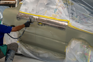 Car body work after the accident by preparing automobile for painting during repair