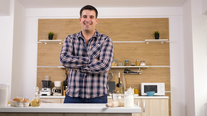 Potrait of young man in his kitchen. Handsome man