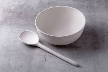 Empty blank white ceramic Bowl and spoon on Cement Board