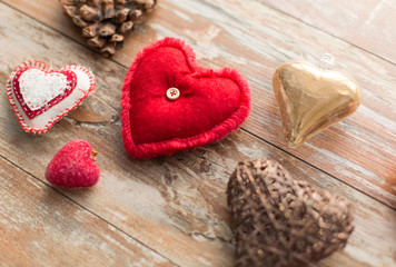 christmas, valentines day and holidays concept - heart shaped decorations on wooden background