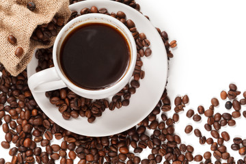 A Cup of strong coffee and a textile bag in roasted coffee beans, on a white background, isolated