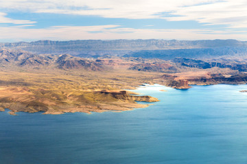 Fototapeta na wymiar landscape and nature concept - aerial view of grand canyon and lake mead from helicopter