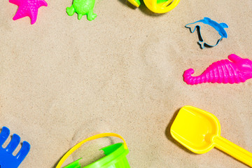 Fototapeta na wymiar childhood and summer concept - close up of sand toys kit on beach