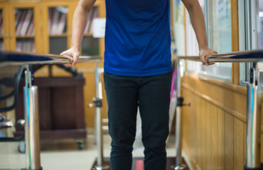 patient on parallel bar.