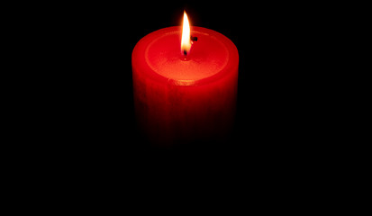 Red candle in the darkness