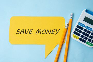 Save money inscription on yellow speech bubble, blue background. Financial concept, savings.