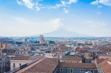 Catania rooftops and cityscape with Mount Etna, active volcano in the background, Sicily, Italy