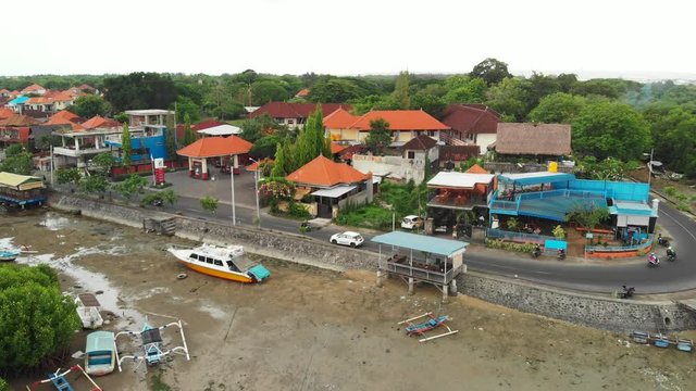 BALI, INDONESIA - DECEMBER 19, 2018: Aerial view drone video of young couple in fish restaurant outdoor. Bali island.