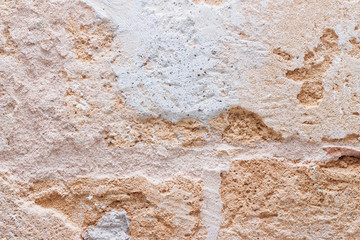 Rough weathered natural old stone wall background, various colored