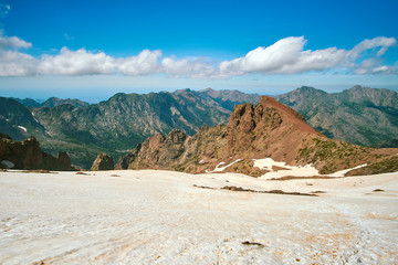 Valley in corsica mountain range from the snowfield under the highest peak Monte Cinto GR20