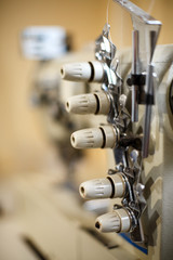 closeup details on sewing machine overlock. Workplace seamstress.Tailoring industry