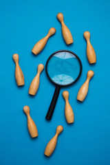 Recruitment concept. Magnifying glass with wooden people. Talent, Job, Opportunity concept