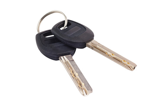 Pair of metal shiny keys with black plastic or rubber handle attached of keyring for door or car isolated on white background