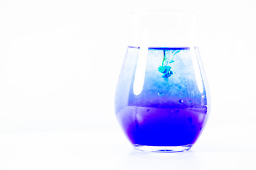 a drop of paint in a jar of water
