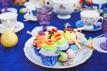 Tea party with cupcakes and different colorful cups