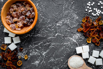 sugar lumps for sweet food cooking on kitchen dark table top vie