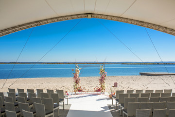 Obraz premium Event decoration. Wedding chuppa at riverside decorated with fresh flowers. Florist workflow