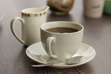 cup of coffeee with milk jug 