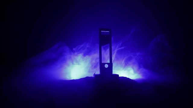 Horror view of Guillotine. Human at guillotine on a dark foggy background. Execution concept
