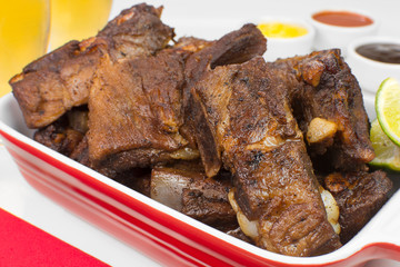 Fried pork rib in a white pub table close