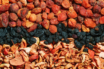 Healthy food. Background of dried fruit. Rows of dried apricots, pears, raisins, apples, prunes