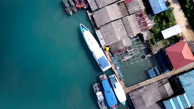 Aerial of ferry speedboat and fishing boat cast anchor at port, kho kood, thailand