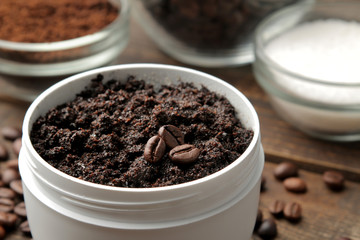 homemade coffee scrub in a white jar for the face and body and various ingredients for making scrub. spa. cosmetics. care cosmetics