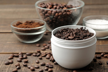 homemade coffee scrub in a white jar for the face and body and various ingredients for making scrub. spa. cosmetics. care cosmetics