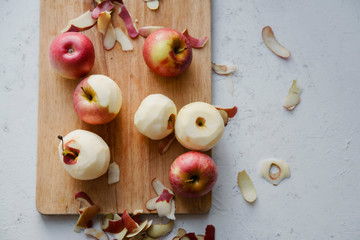 Peeling red apples for cooking an apple pie