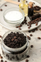 homemade coffee scrub in a jar for the face and body, and various ingredients for making scrub on a light background. spa. cosmetics. care cosmetics.