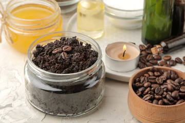 homemade coffee scrub in a jar for the face and body, and various ingredients for making scrub on a light background. spa. cosmetics. care cosmetics.