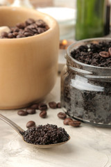 homemade coffee scrub for face and body in a spoon close-up on a light background. care cosmetics.